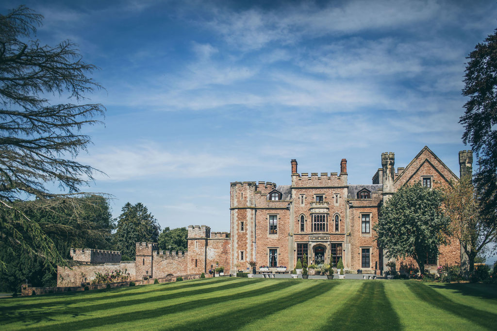 Rowton Castle from the front. Photographed on a sunny day, the lawns are striped