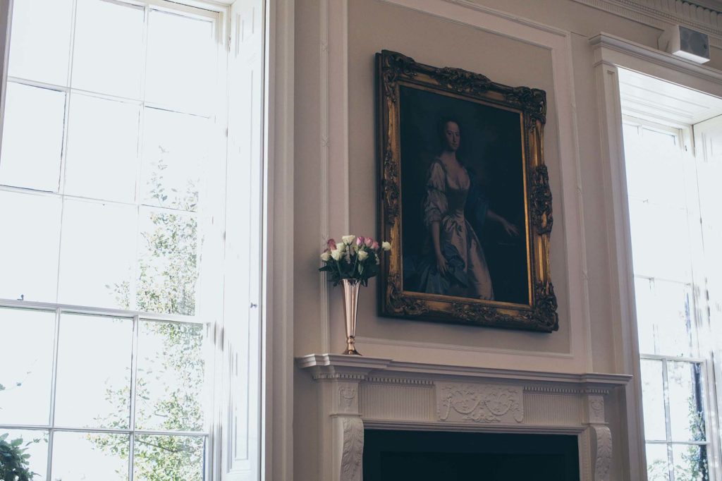 Newly decorated Cardeston I is photographed, an large ornate frame with a portrait of a woman sits above the fireplace