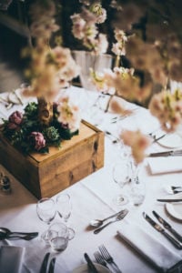 Close up of the wedding breakfast table at Rowton Castle with white linen, and pink blossom trees