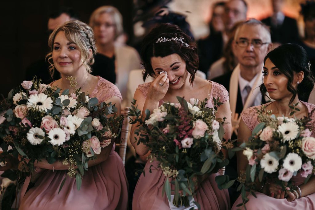 Bridesmaids shed a tear during the wedding ceremony of Rebecca and Arthur