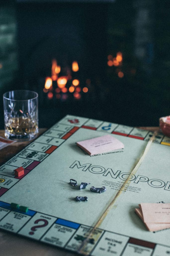 Monopoly is played in front of the fire in the castle lounge, glasses of whiskey are enjoyed