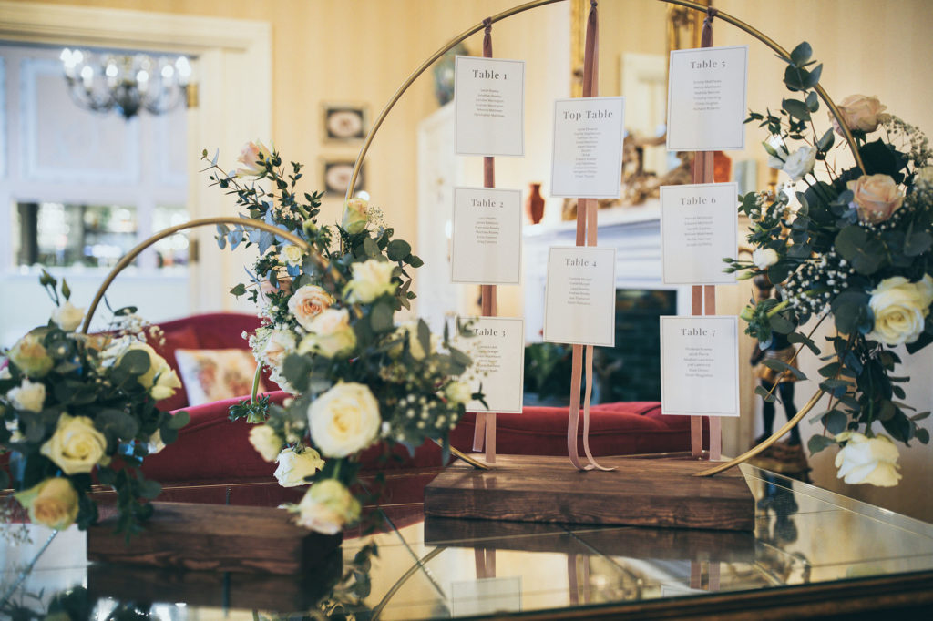 Rowton Castle's rustic moongate table plan is photographed on the glass table in the lounge