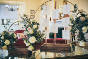 Rowton Castle&#039;s rustic moongate table plan is photographed on the glass table in the lounge