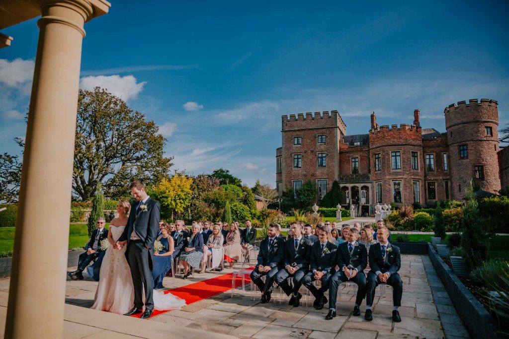 Glorious Rowton Castle commands attention in the back of this outdoor ceremony shot