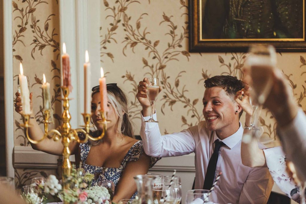 Guests raise their glasses during the speeches at this Rowton Castle Wedding