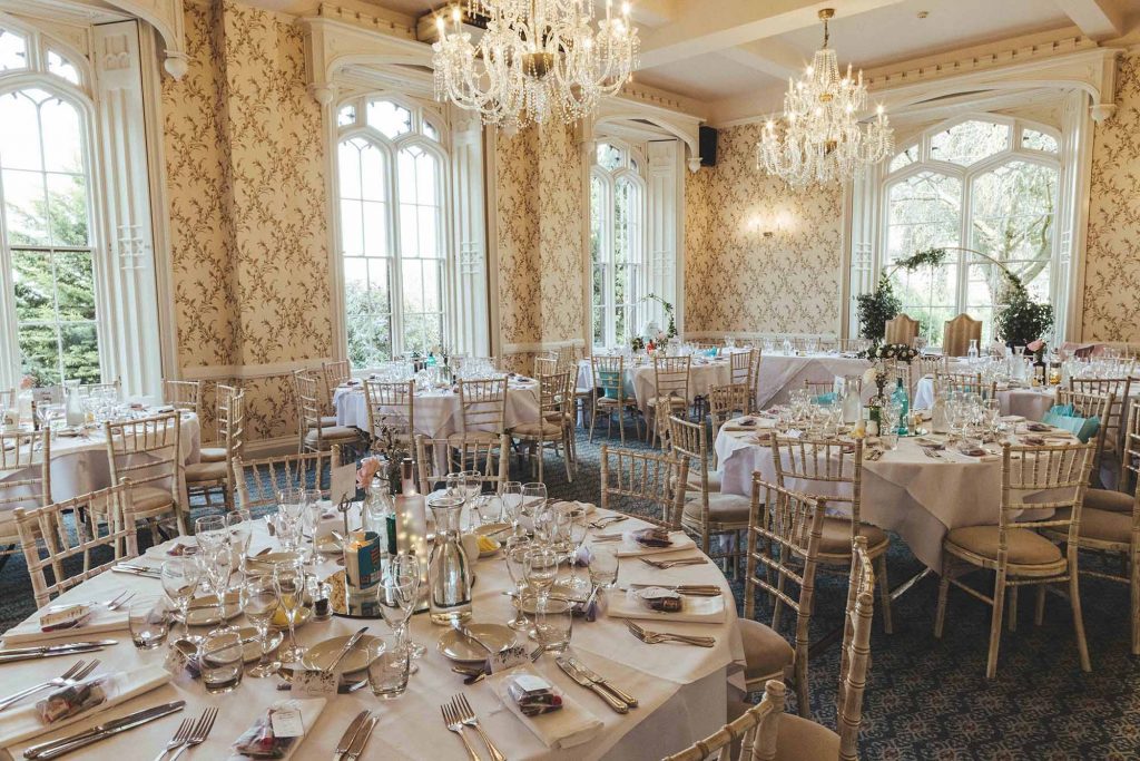 Rowton Castle's Cardeston Suite is photographed set with tables and chairs ready for the Wedding Breakfast to begin