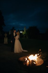 Bride and Groom (Taylor &amp; Chris) take a walk in the gardens at night, the fire pit is ablaze