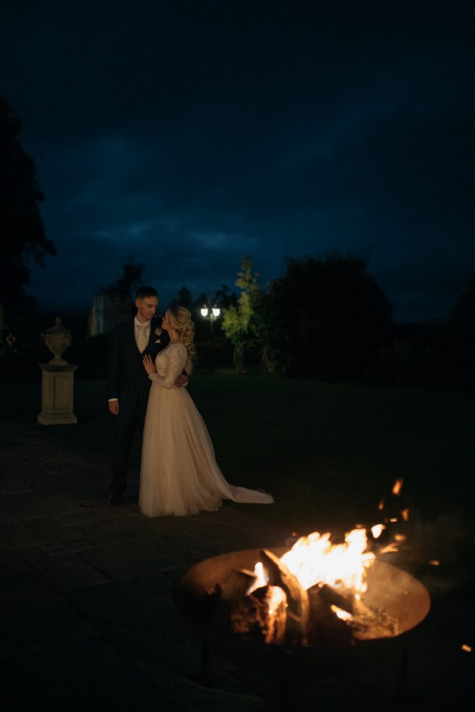 Bride and Groom (Taylor & Chris) take a walk in the gardens at night, the fire pit is ablaze
