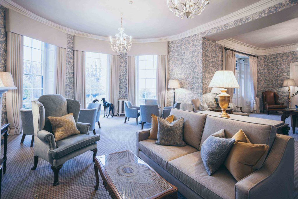 Rowton Castle lounge is photographed here, post refurbishment, its Lewis & Wood wallpaper taking centre stage
