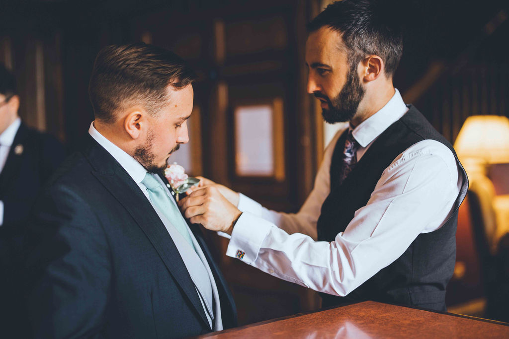 General Manager Gareth helps groom Alex with his buttonhole ahead of the wedding ceremony