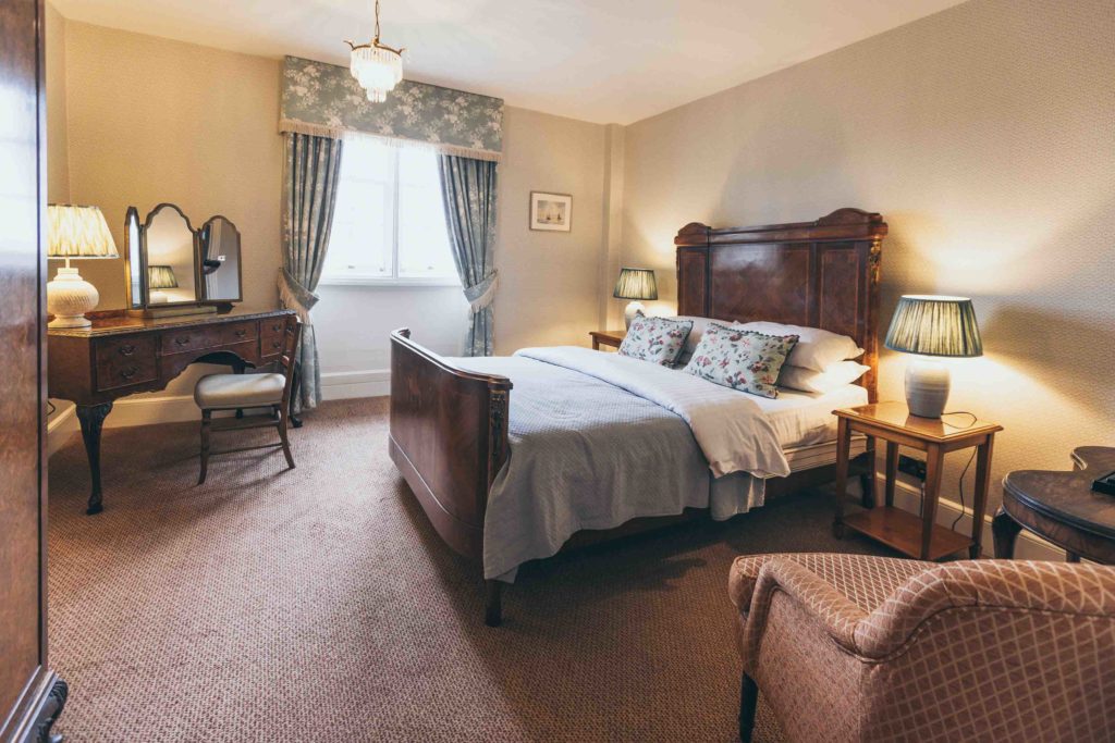 One of Rowton Castle's Classic Double Bedrooms, Room 17 is made up in Blue and Light Wood and Has Floral Accents