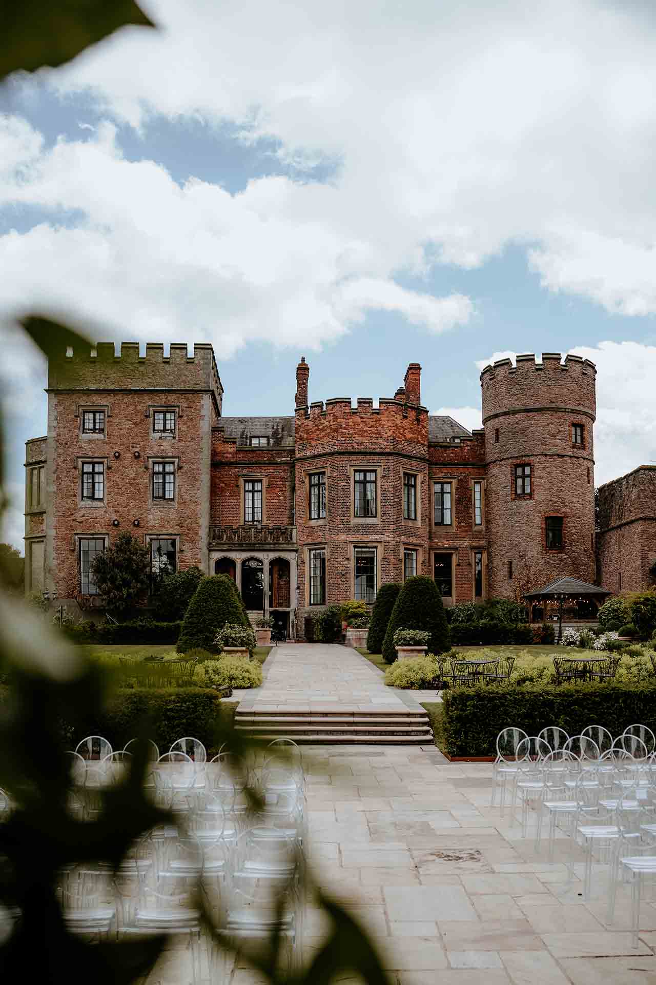 Rowton Castle exterior with gardens and outdoor ceremony seating in Shropshire