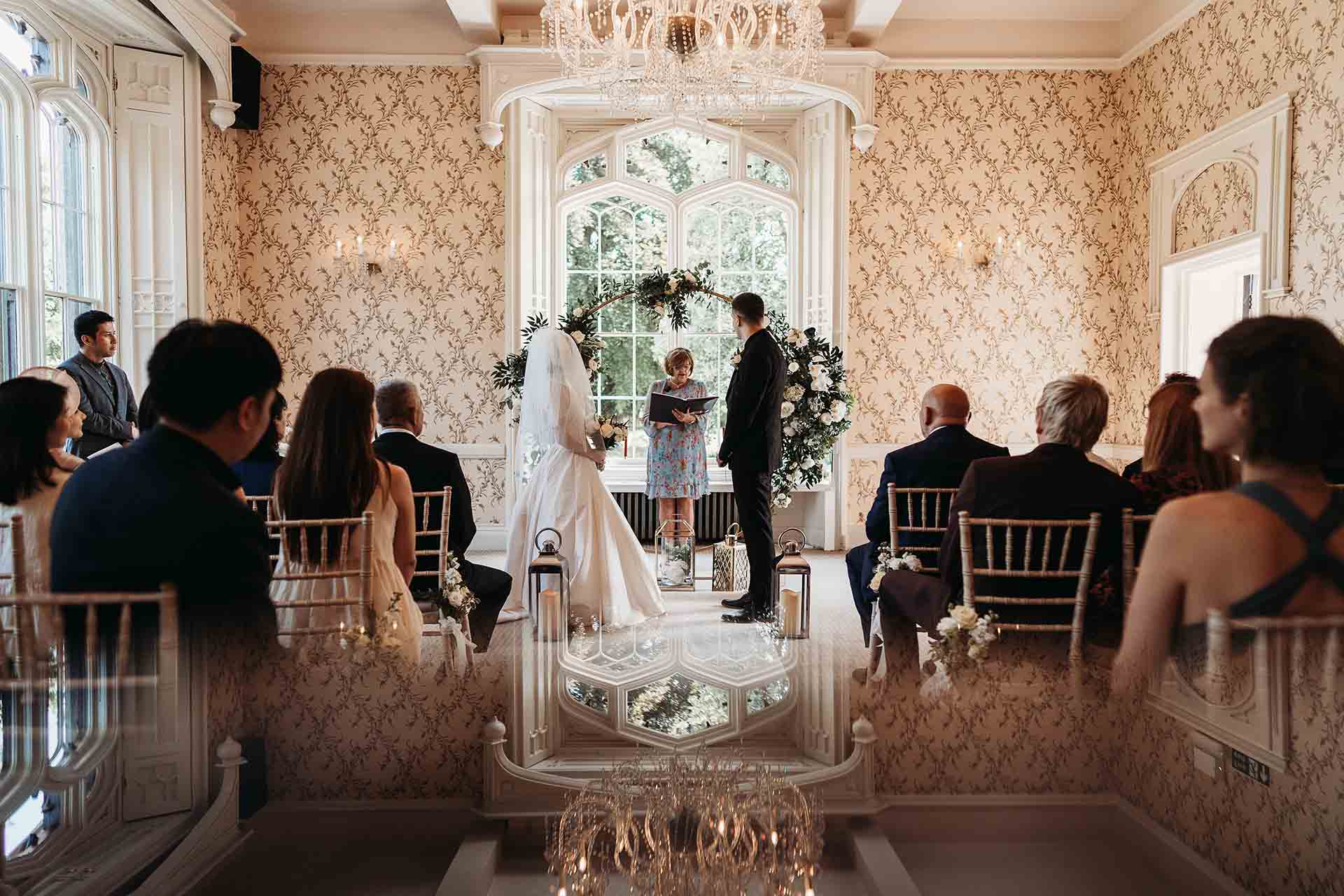 Wedding ceremony taking place inside the Rowton Castle ceremony room with guests seated