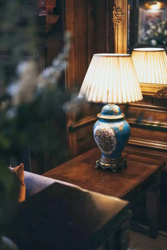 Elegant interior at Rowton Castle featuring a traditional table lamp, wooden panelling, and classic décor