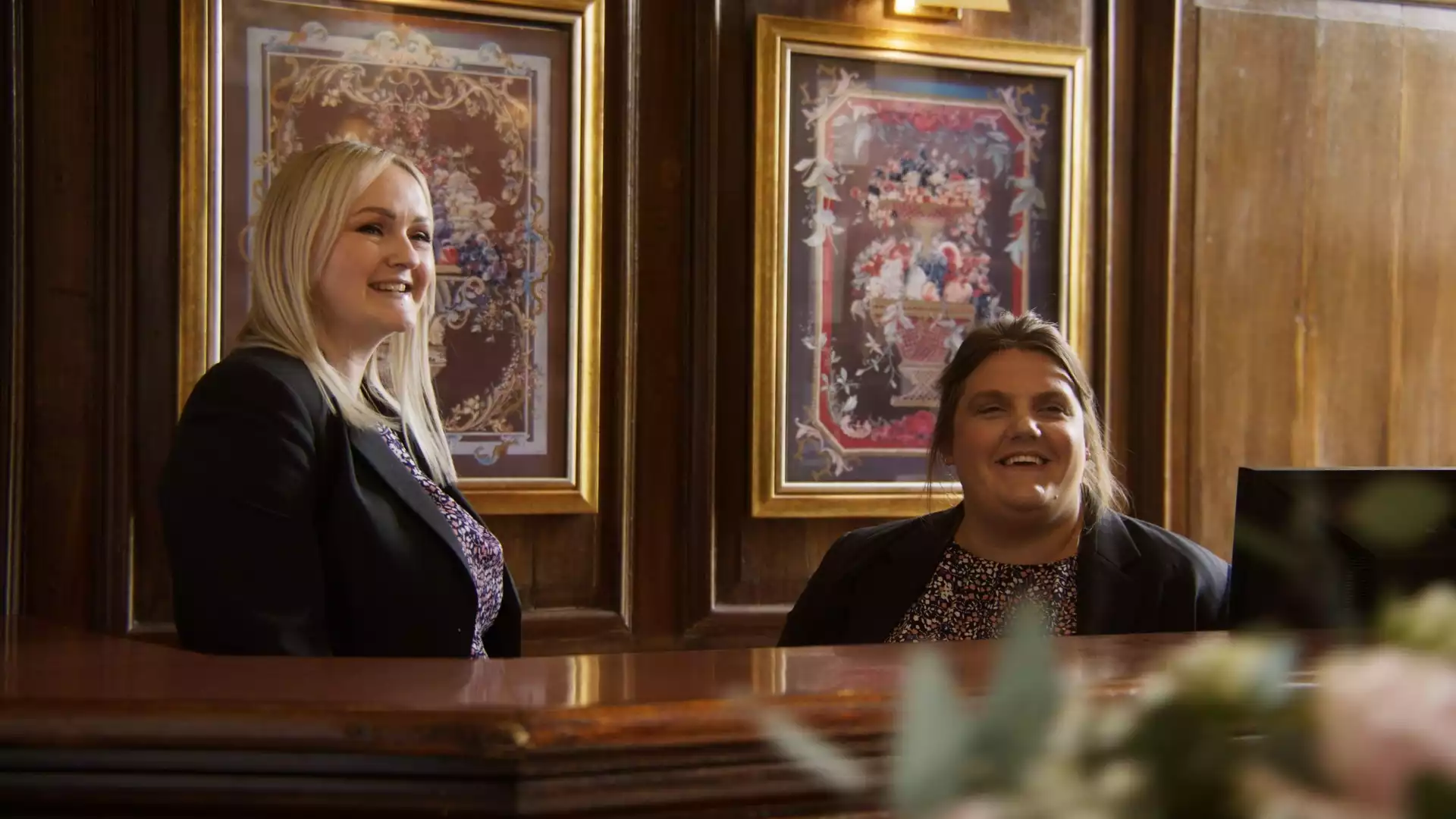 Rowton Castle wedding team welcoming guests at the reception desk