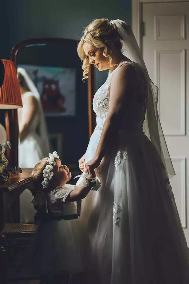 Bride admiring her wedding dress before getting ready