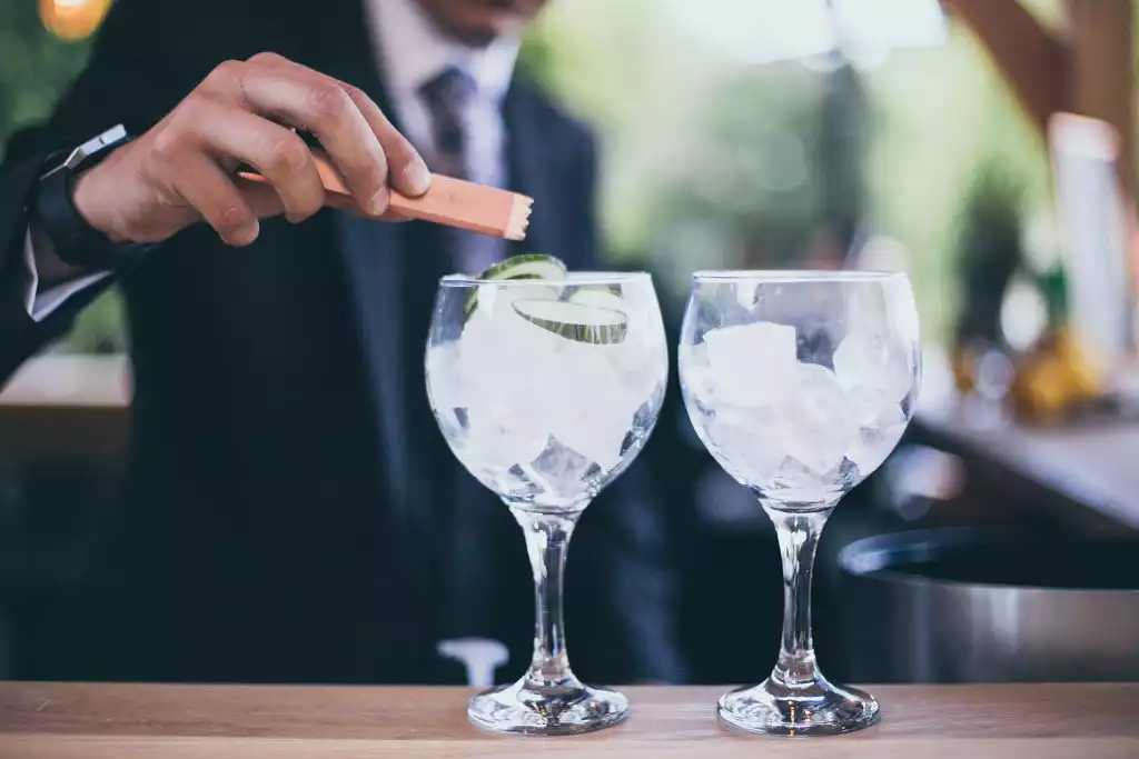 Bartender preparing gin and tonic cocktails during a Rowton Castle wedding reception