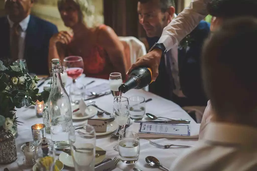 Champagne being poured for guests during a wedding reception at Rowton Castle