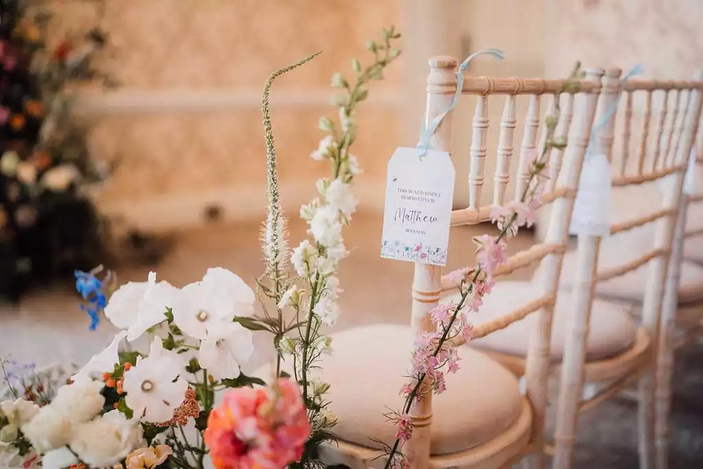Wedding ceremony chair decoration with flowers and reserved seat tag at Rowton Castle
