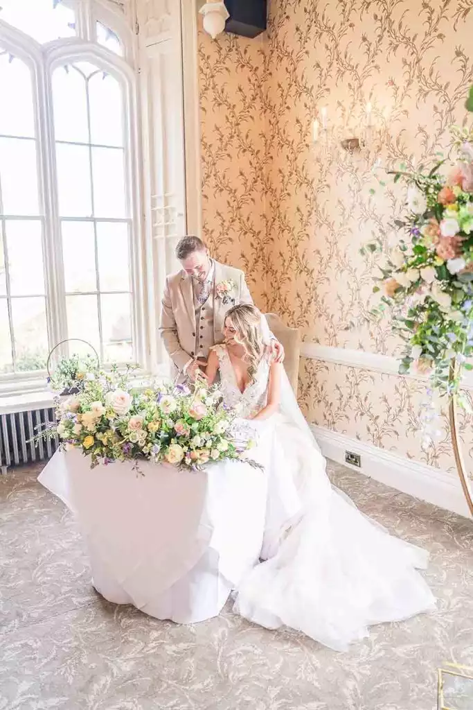 Bride and groom signing the wedding register inside Rowton Castle ceremony room