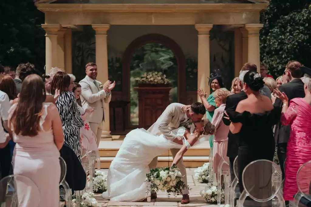 Bride and groom sharing their first kiss at the Rowton Castle outdoor temple ceremony